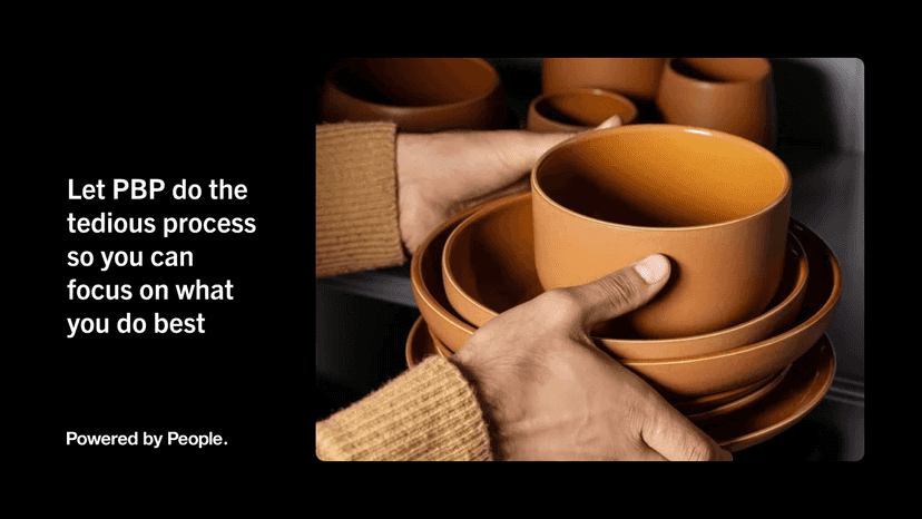 Closeup shot of a mans hands placing a stack of terracotta bowls